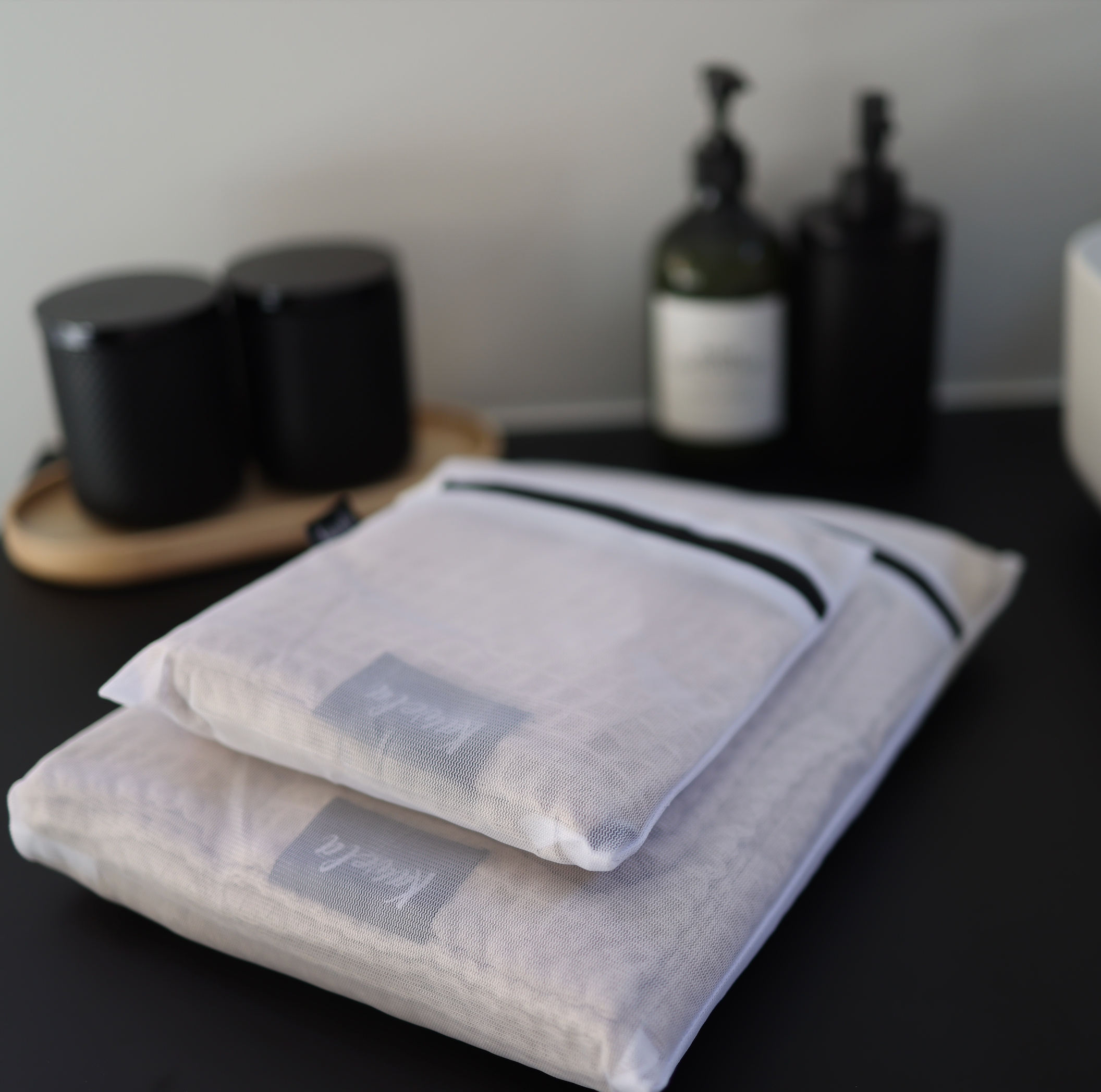 Serviette de bain NUDA de la marque KAWELÄ, tissu doux et absorbant, couleur neutre, pliée sur une surface en bois.