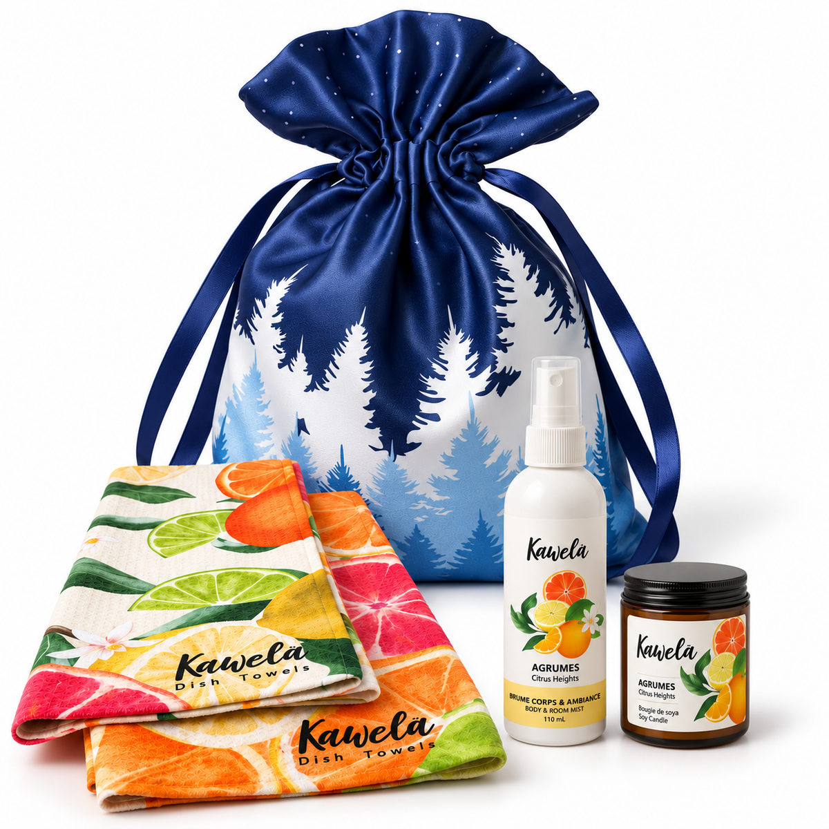 Coffret cadeau Kawelä Essentiels du quotidien avec produits de soins aux agrumes devant un décor hivernal