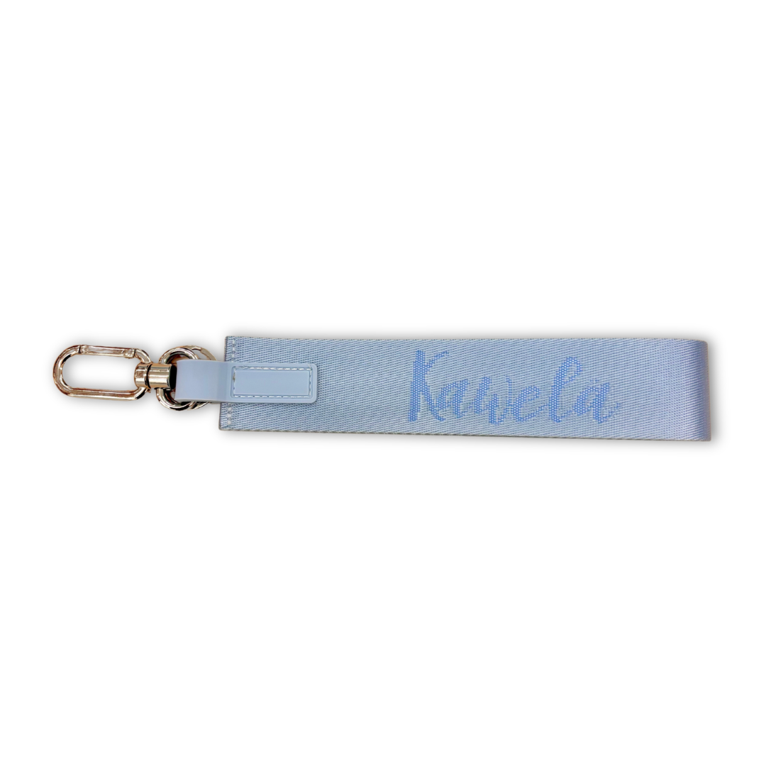 Porte-clé méga en forme de seau bleu de la marque KAWELÄ, avec détails colorés et texture visible.