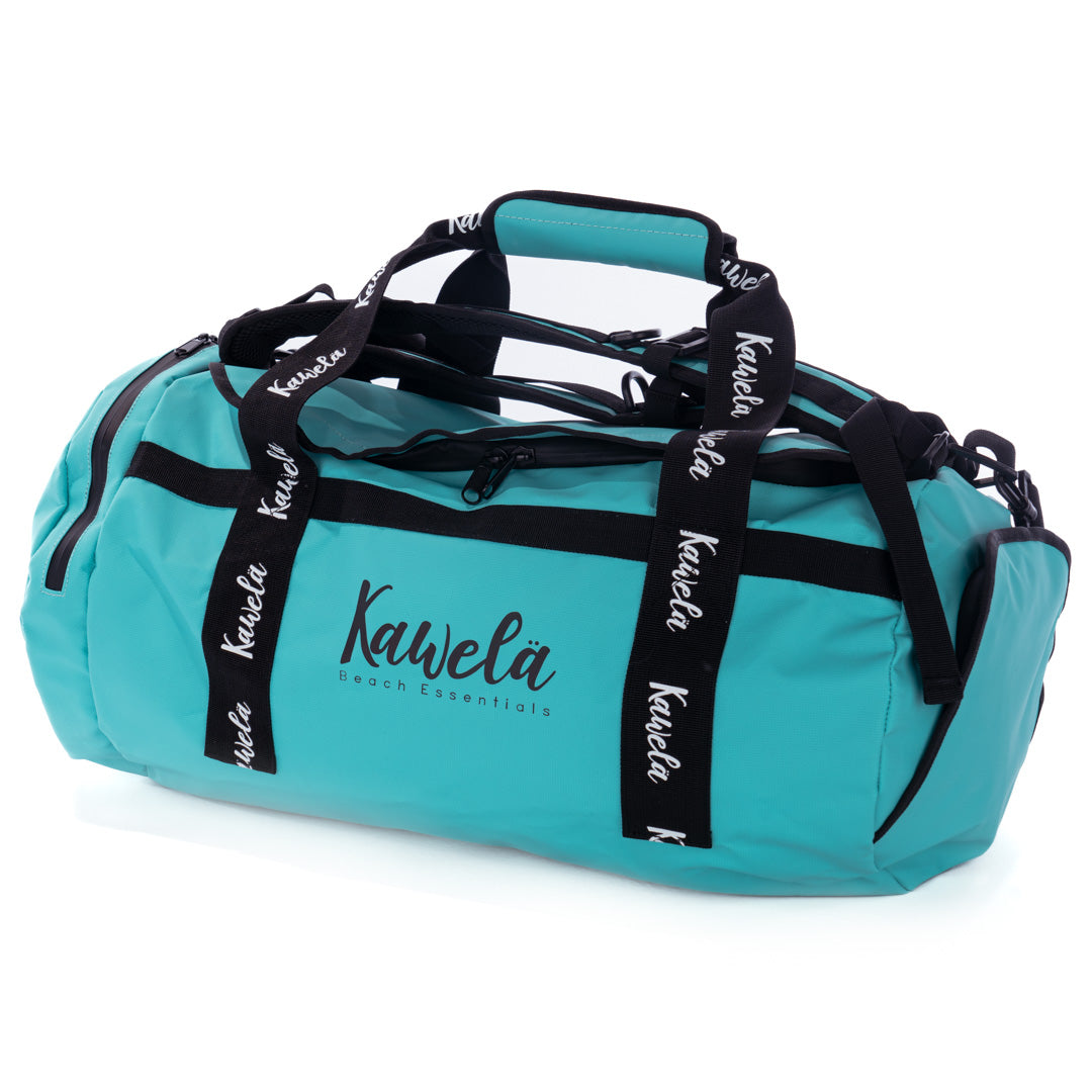 Sac de voyage KAWELÄ ODAIBA en bleu vert, vue de face avec poignées et poches visibles.